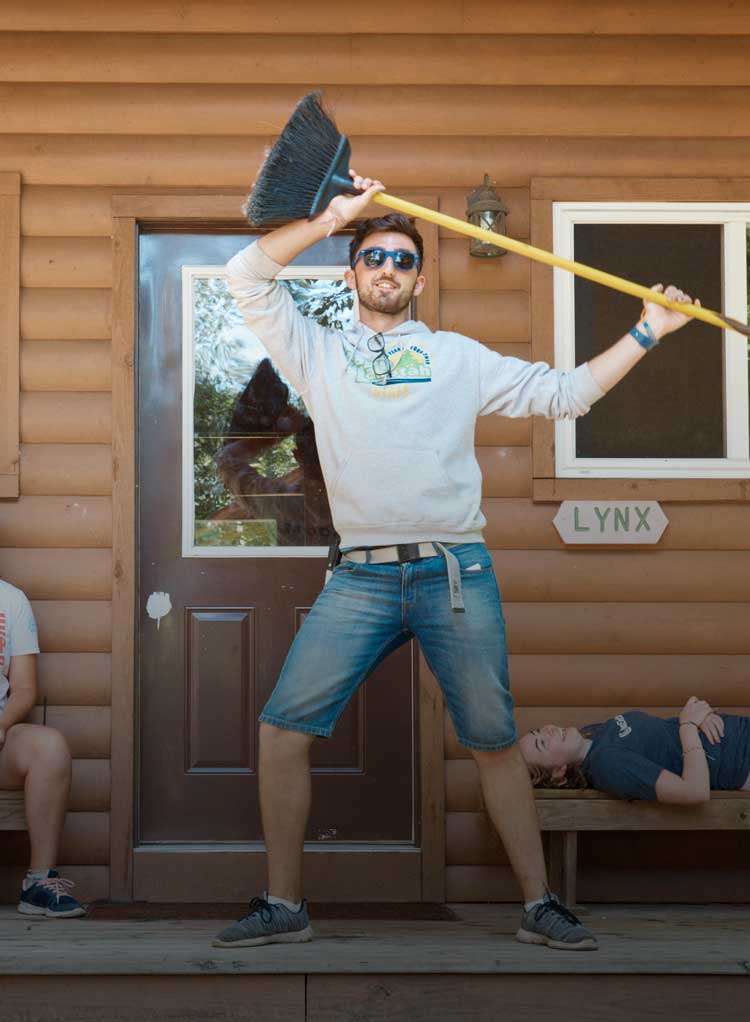 Camp counselor dancing with broom